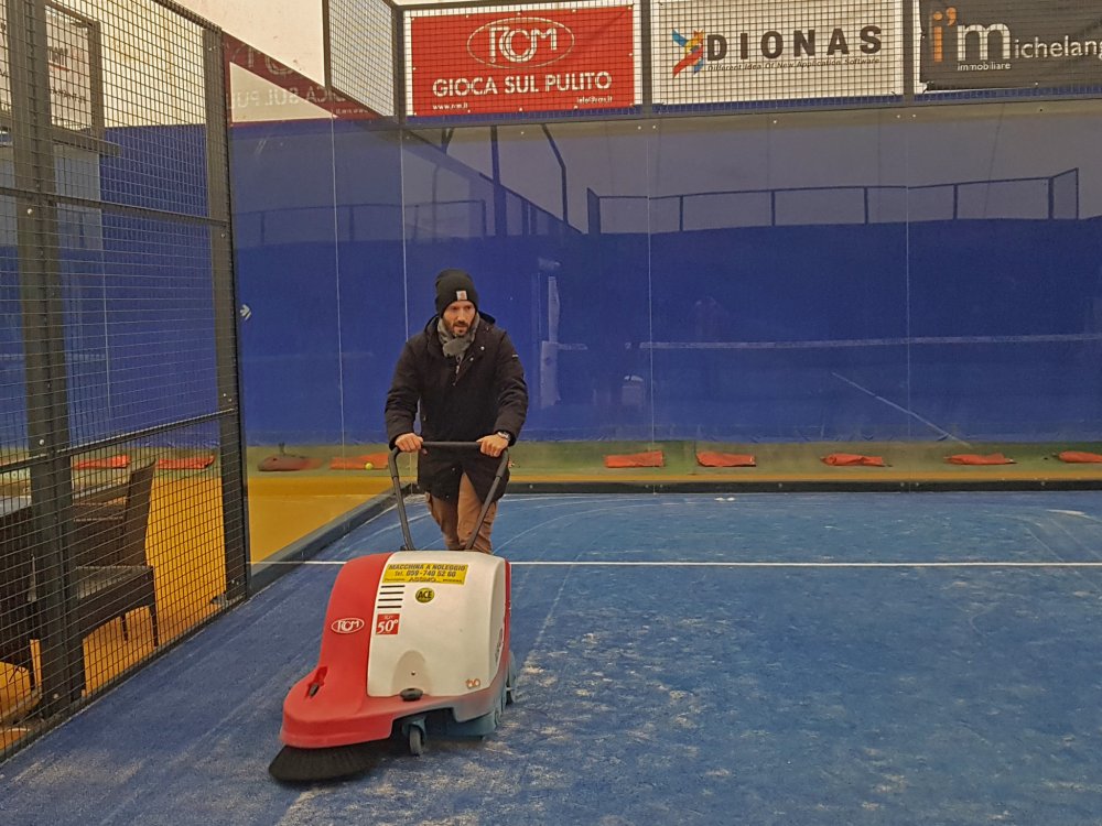 Padel Court Maintenance, man using a Brava sweeper.
