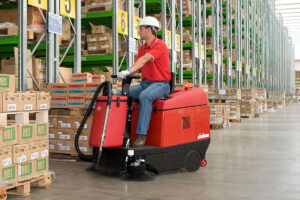 Warehouse Hazards, person riding a ride-on sweeper from Euromec.