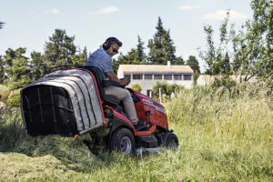 An operator mowing a lawn on a Honda ride-on mower