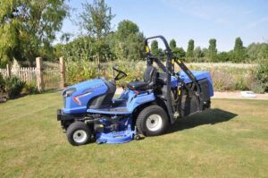 Ride-on mower with grass collector cutting a large lawn in a landscaped park setting